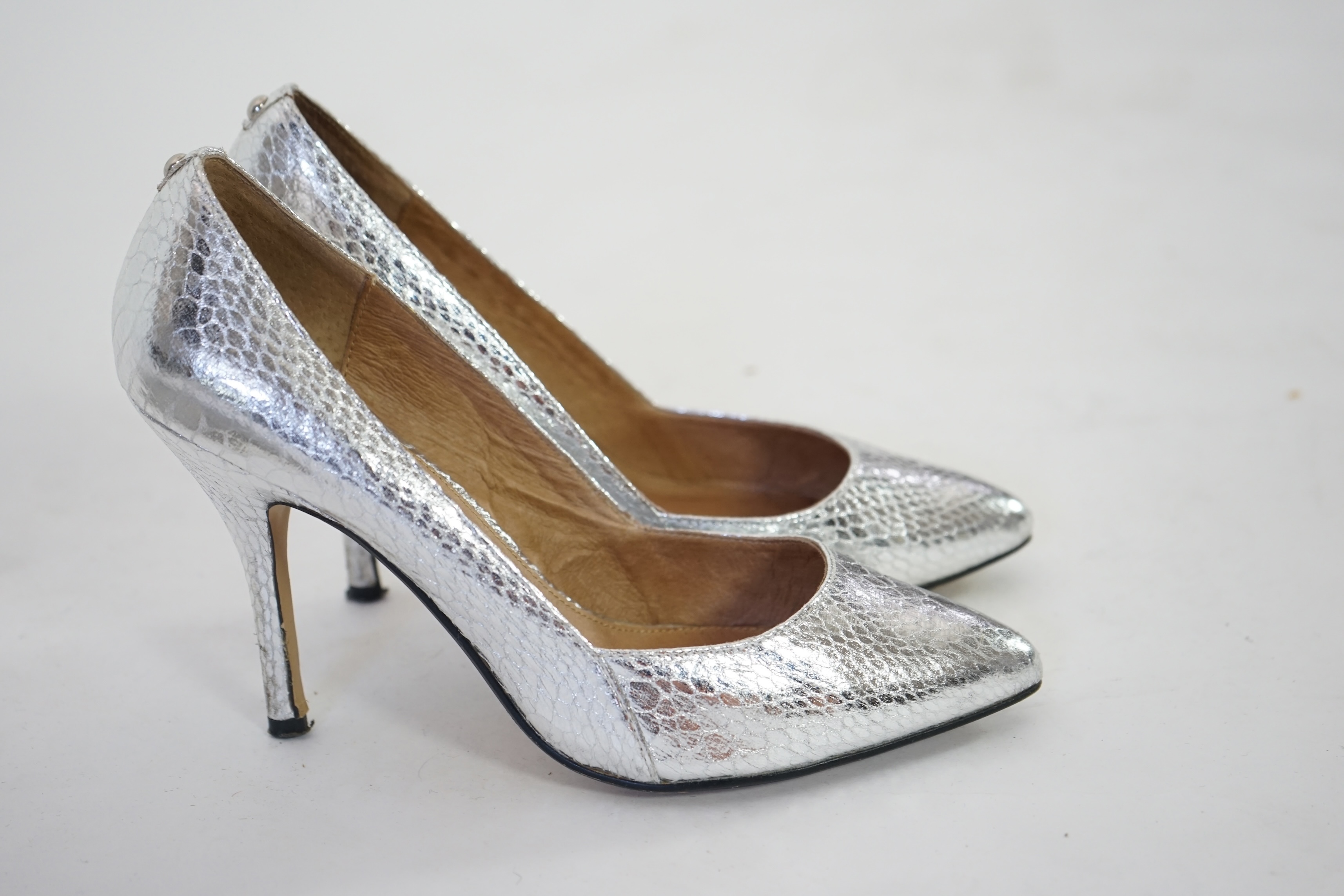 Three pairs of lady's silver shoes: Rodo silver diamonté sling back heels, Moda in Pelle silver snakeskin pattern heeled pumps and a pair of Stuart Weitzman clear jelly's with crystals. Size 38.5 (UK 4). Proceeds to Happ